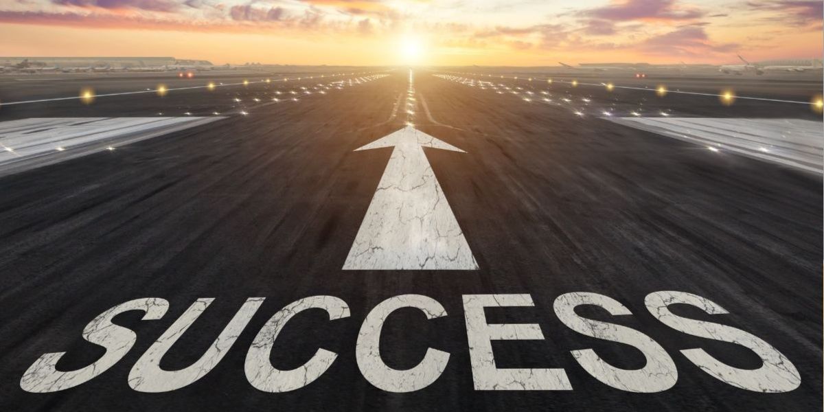 A runway with the word “SUCCESS” and an arrow pointing toward a bright sunrise, symbolizing a mortgage loan officer’s journey toward growth and achievement through key success factors.