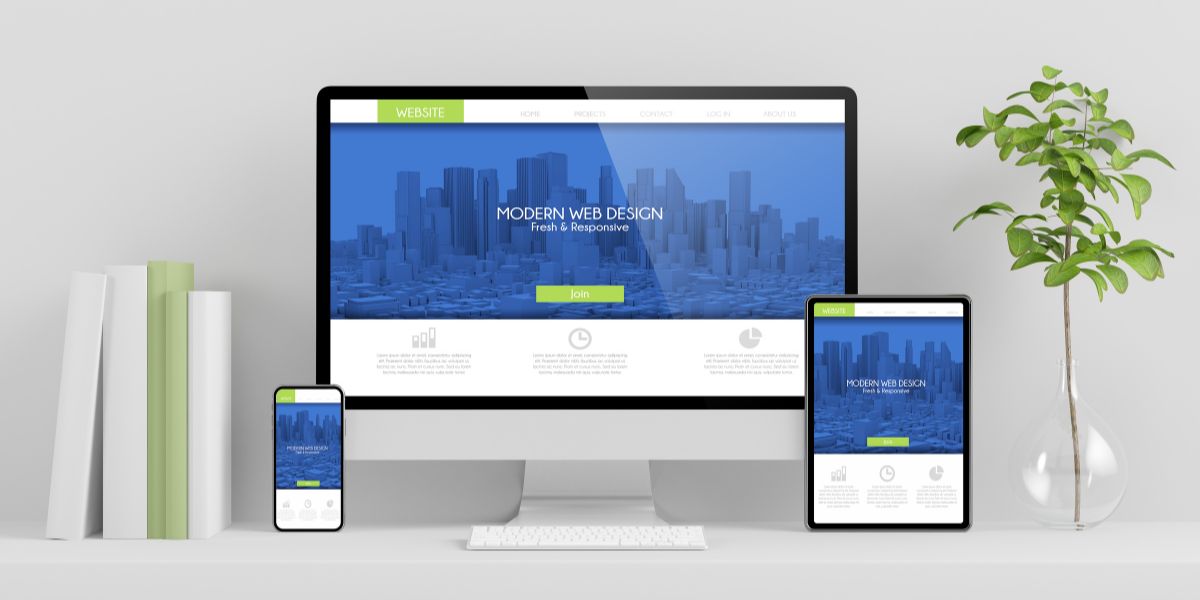 Multi device mockup of modern web design showing a blue and white website.
